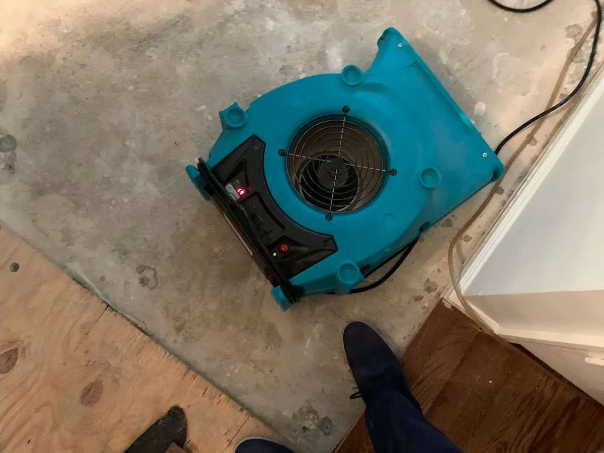 Air mover drying subfloor during Leak Detection & Repair in Bridgeton